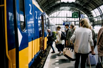 People getting on a train.