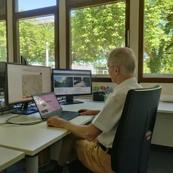 Picture of a man sitting in front of a computer