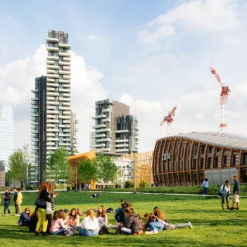 People relax in Biblioteca degli alberi park in Gae Aulenti square.