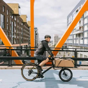 Cargo bike courier riding through the city