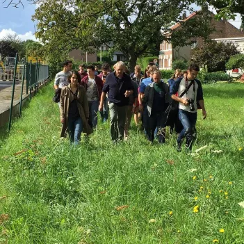 picture of people walking over a meadow
