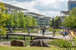 Modern offices in a business park, situated around a pond.
