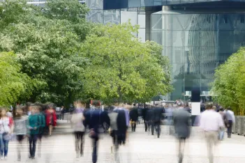 Commuters walking in a financial district.