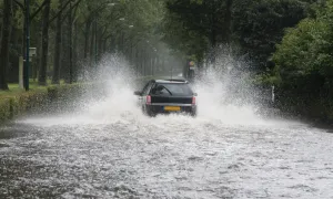 Car driving through a flooded street
