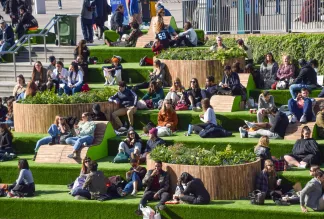 People enjoy the sunshine on the steps at Granary Square in King's Cross as the UK.