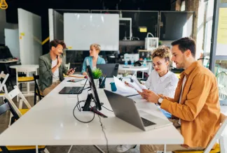 A diverse group of business people is in the office.