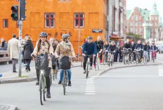 People going by bike in the city. A lot of commuters, students and tourists prefer using bike instead of car or bus to move around the city.