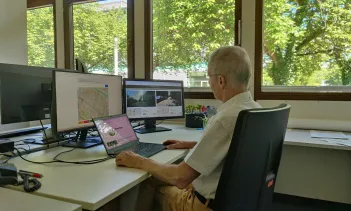 Picture of a man sitting in front of a computer