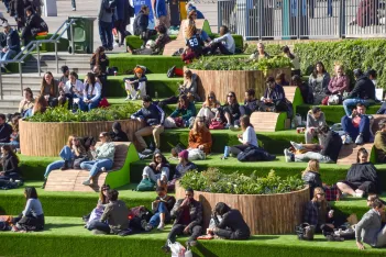 People enjoy the sunshine on the steps at Granary Square in King's Cross as the UK.
