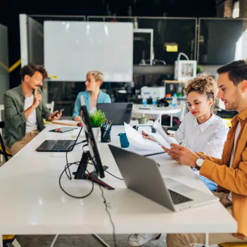 A diverse group of business people is in the office.
