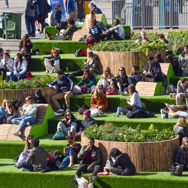 People enjoy the sunshine on the steps at Granary Square in King's Cross as the UK.
